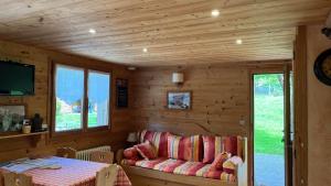 a room with a couch and a table in a cabin at Vieille Bergerie 5 in Le Fernuy +7 photos