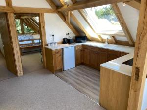 a kitchen with wooden cabinets and a white refrigerator at Spirit Lake in Dorking