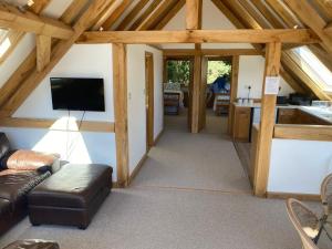 a living room with a couch and a tv at Spirit Lake in Dorking