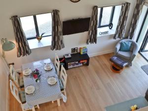 a dining room with a table and chairs at Ty Isaf Cottage in Ffair-fâch +15 photos