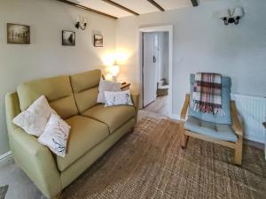 a living room with a couch and a chair at Seashell Cottage - Uk48616 in Flamborough