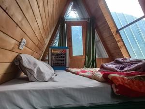 a room with two beds in a attic at Skytouch cottage stargazing in Jibhi +1 photo