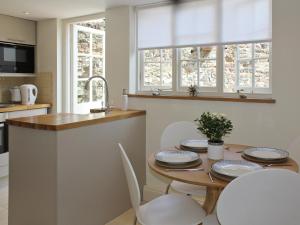 a kitchen with a table with chairs and a sink at Anchor Cottage in Deal