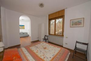 a bedroom with a large bed and a window at Marzola in Trento