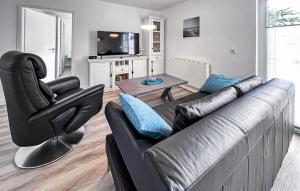 un salon avec un canapé et une chaise dans l'établissement Ferienhaus Fuhlendorf, à Fuhlendorf