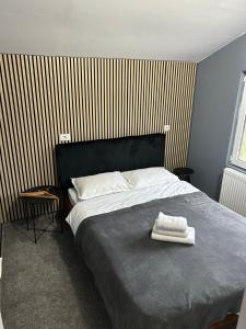a bedroom with a bed with a towel on it at Cabanute Luca Ama Bran in Bran