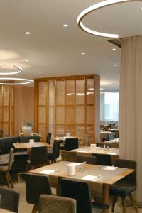a dining room with wooden tables and chairs at Hotel Post Gries in Bolzano