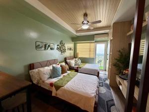 a bedroom with a bed and a couch at Vacay shine tagaytay staycation in Kaybagal