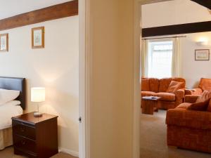 a bedroom with a bed and a living room at Granary - Ukc3373 in West Down