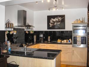a kitchen with a sink and a stove top oven at Holly-Garth in Helmsley
