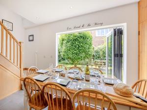 a dining room with a table and chairs and a window at The Nook in Chapel Saint Leonards