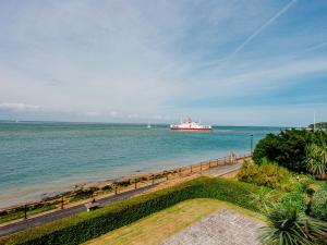 a large boat in the water with a beach at Solent View Apartment in West Cowes