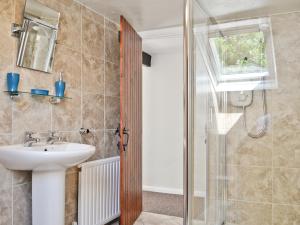 a bathroom with a sink and a shower at The Lodge - 29794 in Swimbridge +2 photos