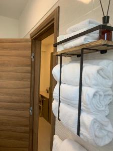 a stack of towels on a shelf in a room at La Candela Affittacamere in Candela