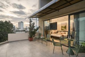 a balcony with a view of a bedroom at Secret Garden Hotel Bình Thạnh in Ho Chi Minh City