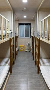 a row of bunk beds in a dorm room at 안리하우스광안 in Kwangan-dong