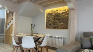 a living room with a table and chairs and a couch at Casa Briz in Ojedo +42 photos