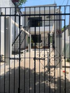 a wrought iron fence in front of a building at Quarto em casa arborizada in Belém