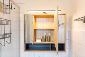 a medicine cabinet in a bathroom with a shower at Ruhestein Quartier - Charaktervolle Wohnung perfekt für Gruppen&Familien, ideale Lage, nahe Bhf, bestens geeignet für entspannte als auch akitve Aufenthalte in malerischer Umgebung in Baiersbronn +68 photos