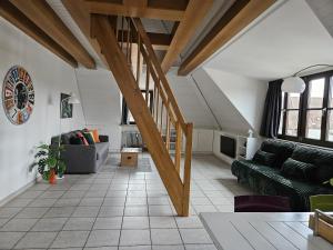 a living room with wooden beams and a couch at Ferienwohnung 2 ANNA IFF in Würzburg