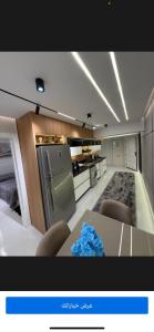 a kitchen with a table and chairs in a room at Sky Sokhna -قمة التجربة الفاخرة مع بورتو رينتال in Ain Sokhna