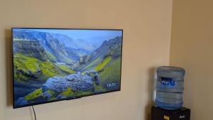 a flat screen tv hanging on a wall at The Loch in Naivasha
