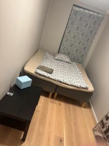 un piccolo letto in una stanza con un tavolo di Solheim a Lillestrøm