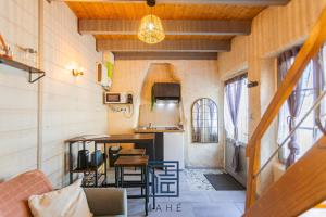 a tiny house with a kitchen and a living room at La petite maison du Port de Tréguier in Tréguier