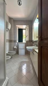 a large bathroom with two sinks and two toilets at Acquafredda Ritrovata in Acquafredda