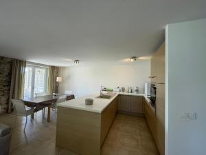 a kitchen with a counter and a table in a room at Appartement Rez de chaussée in La Celle-sous-Gouzon +5 photos