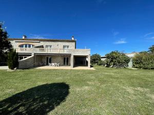 a large house with a large yard in front of it at Appartement Rez de chaussée in La Celle-sous-Gouzon