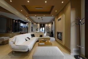 a living room with a couch and a table at Villa Under Meteora in Kalabaka