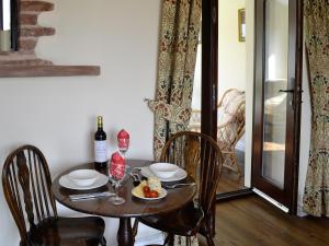 a table with a plate of food and a bottle of wine at Bruno's Bothy in Wigton