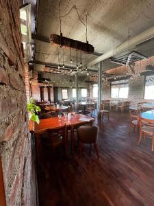 a restaurant with tables and chairs and a brick wall at Terrazas Suite in Potrero de Garay +15 photos