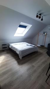 a bedroom with a bed and a ceiling with a light at Les tournesols in Woincourt