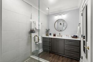 a bathroom with a shower and a sink and a mirror at Water Street Retreat Walk To Casinos, Restaurants in Biloxi