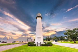 a lighthouse on the side of a road at Water Street Retreat Walk To Casinos, Restaurants in Biloxi
