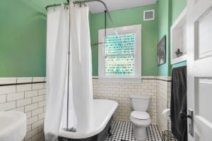 a green bathroom with a toilet and a sink at SaraCasa - First Floor House 2Br/1.5Bath in St. Augustine +20 photos