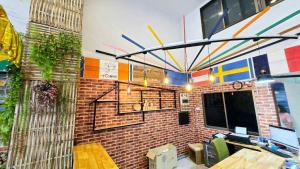 a room with a brick wall with a table and a tablektop at MT friendhome&hostel2 in Phuket