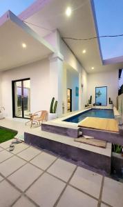 a house with a swimming pool in the yard at Villa Cozy Kapal 1BR private pool in Badung