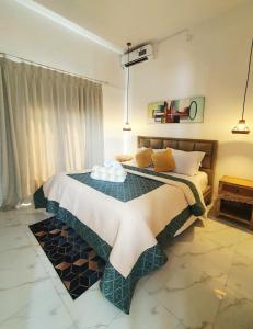 a bedroom with a large bed in a room at Villa Cozy Kapal 1BR private pool in Badung +14 photos