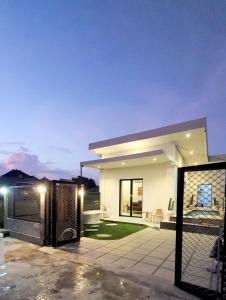 a white house with a fence in front of it at Villa Cozy Kapal 1BR private pool in Badung
