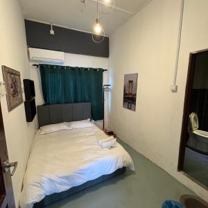 a bedroom with a bed with a green curtain at Ipoh Apartment Suites in Ipoh +32 photos