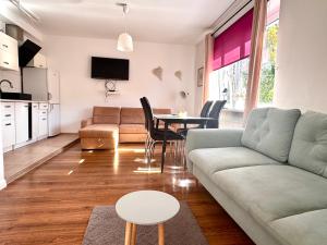 a living room with a couch and a table at Familly Apartament 3 in Międzyzdroje