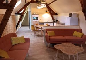 a living room with two couches and a kitchen at La Pause Picarde - Baie De Somme 2 in Franleu