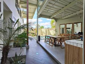 Un patio al aire libre con mesa y sillas. en HŌM Coliving Bali, en Kerobokan