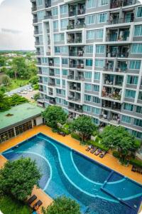 an aerial view of a large apartment building with a swimming pool at Cozy bed with WiFi Pool Gym in Udon in Udon Thani