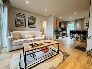 a living room with a couch and a table at Les Alliés in Mulhouse