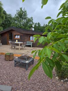 a backyard with a firepit and a house at Chalet piscine chauffée et couverte in Brimeux