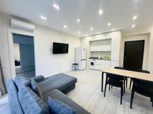 a living room with a couch and a table at GSS - 4 Apartment in Tbilisi City